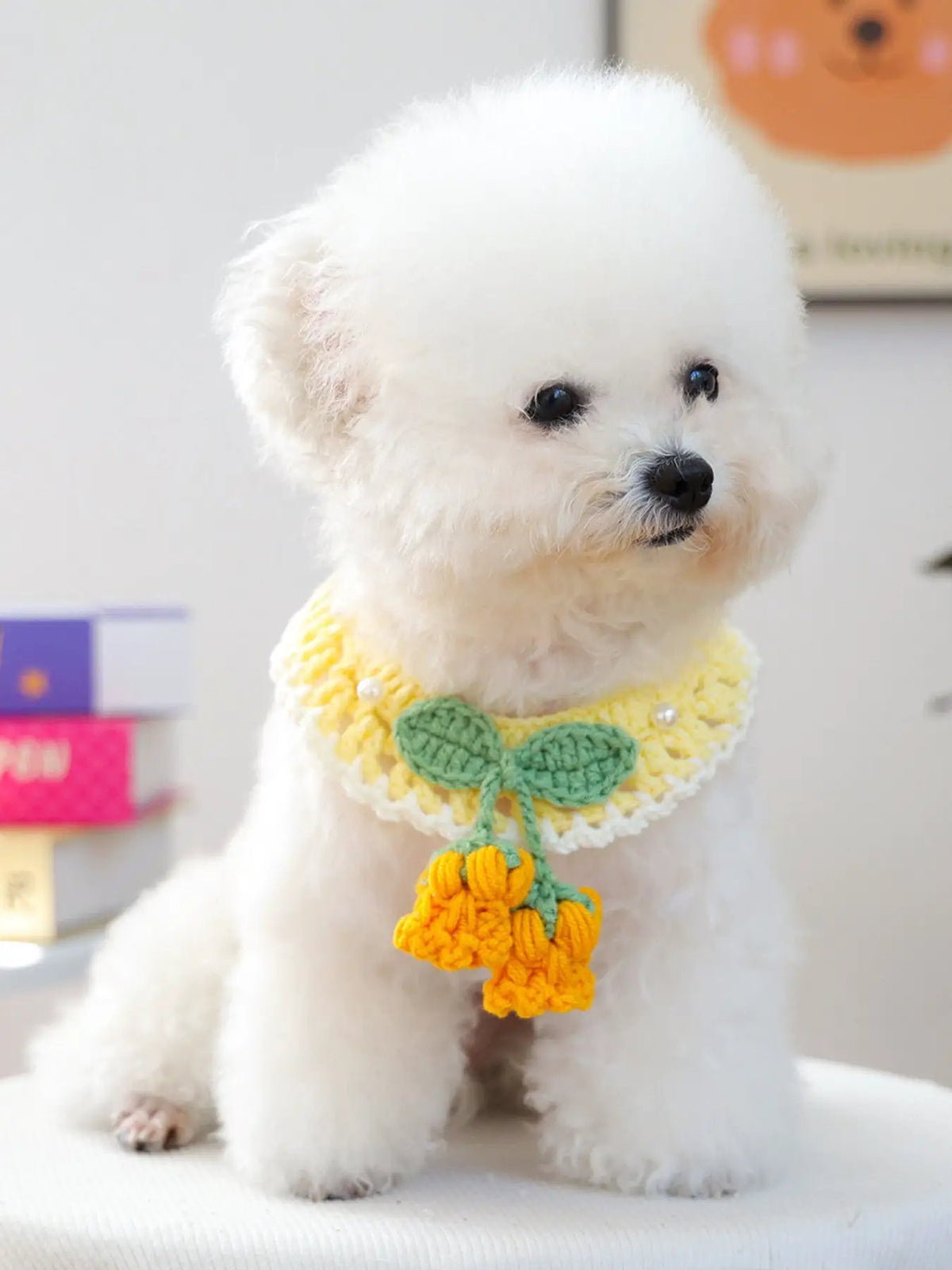Contrast Pet Scarf for dogs; yellow crocheted scarf with green leaves and orange pom-pom tassels.