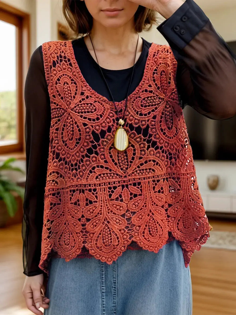 Lightweight cotton sleeveless cover up with scoop neck and rust lace overlay worn over a black top