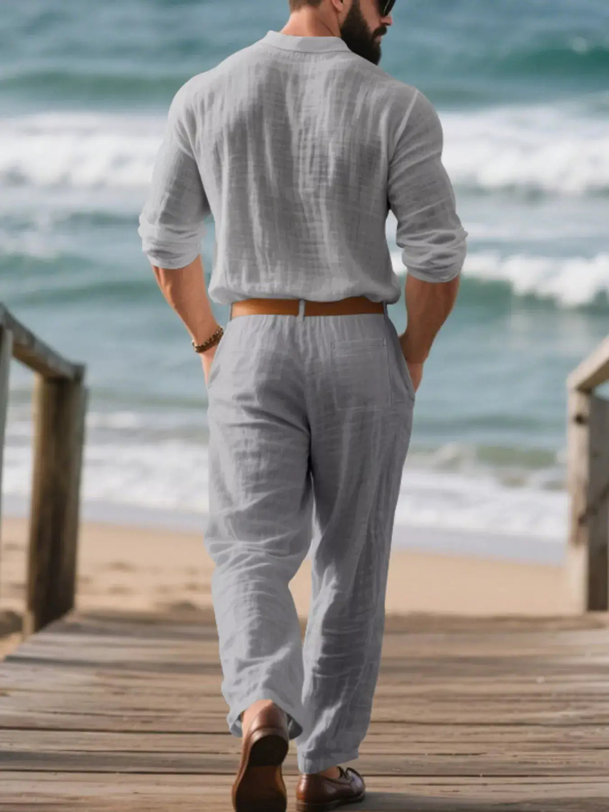 Mens plus-size linen top and pants set in light gray; man walking on a beach boardwalk