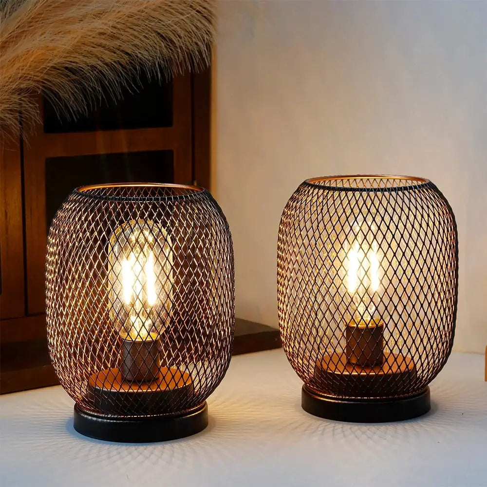Set of 2 tall battery-powered outdoor table lamps with copper lattice mesh cages and warm glow on black bases