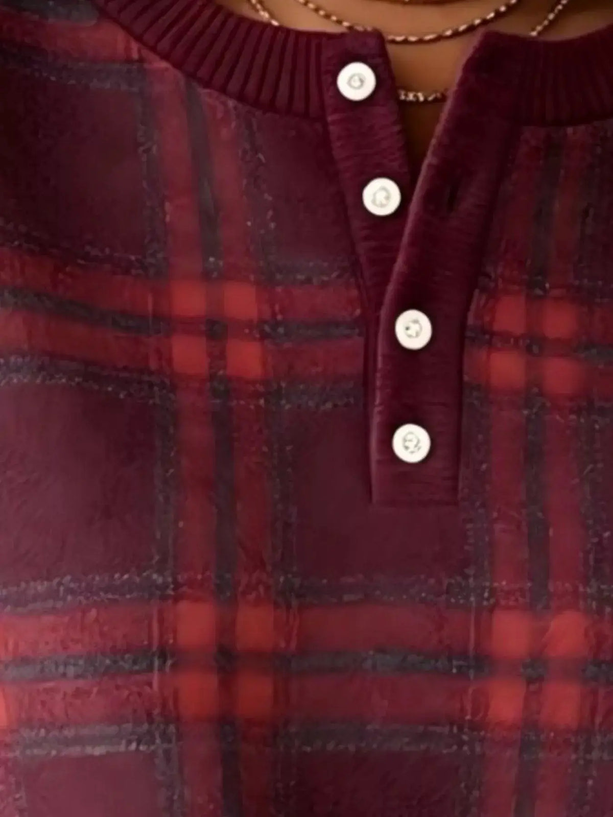 Women's plus-size long-sleeve plaid button-front sweatshirt in red and black with white buttons.