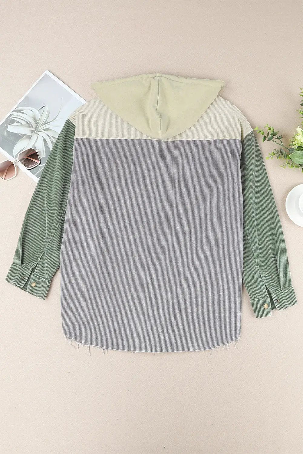 Snap-front hooded corduroy shacket with beige hood, gray body, and green sleeves