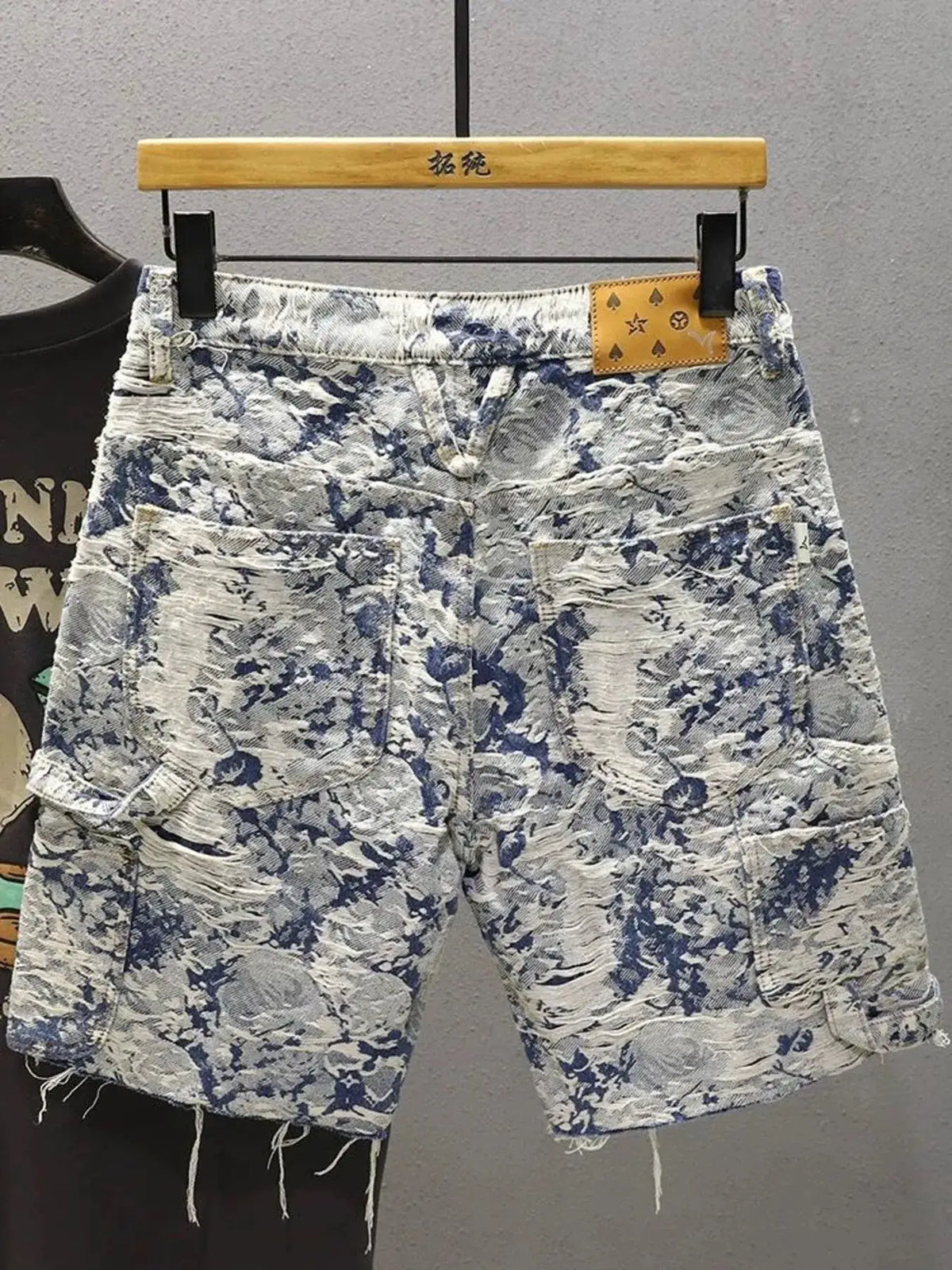 Men's frayed-hem denim shorts in blue and white paint-splatter print, stretch cotton by Trendsi