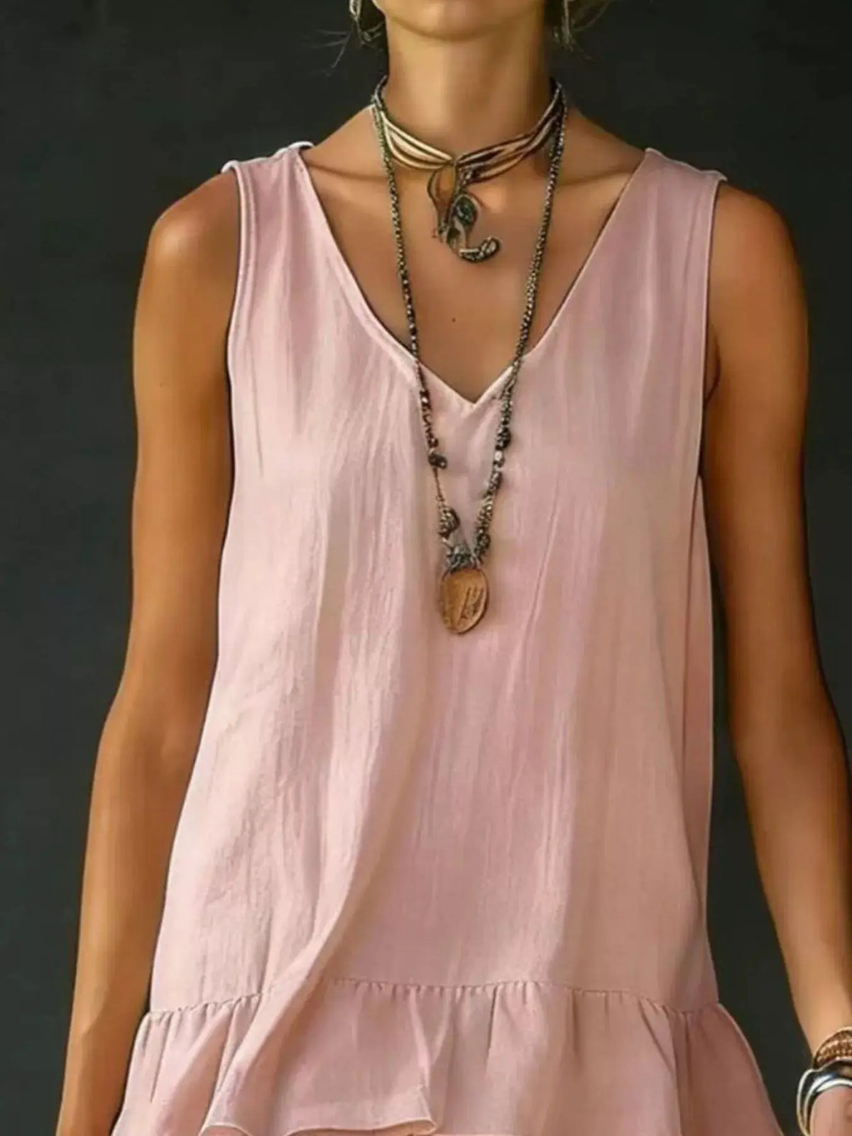 Plus-size V-neck sleeveless dress with a ruffled hem in soft pink by Trendsi