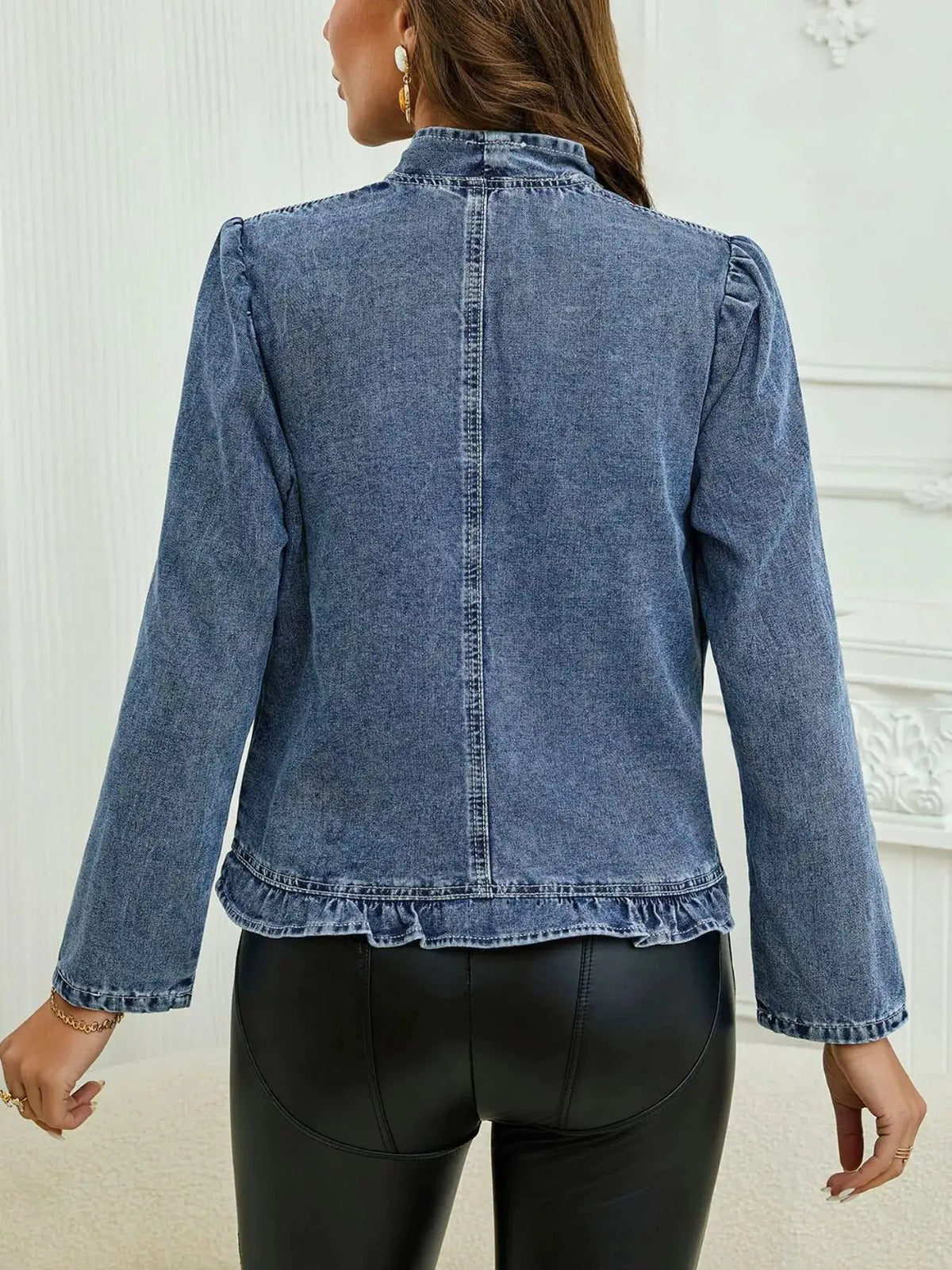 Open-front denim jacket in blue cotton-spandex blend, back view with a ruffled hem and puff sleeves.