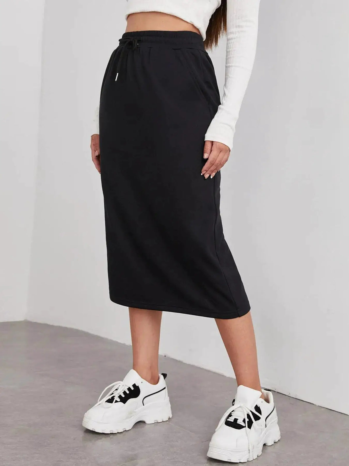 Slit drawstring midi skirt in black with an elastic waistband and relaxed midi length