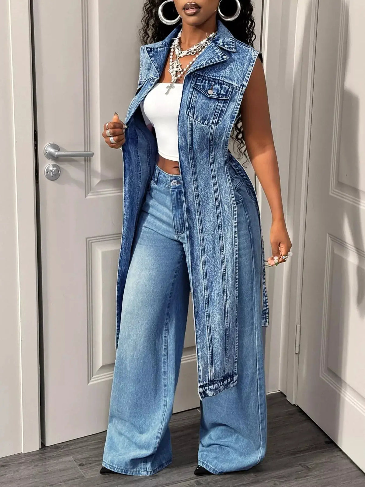 Open-front high-low denim vest with pockets in vintage wash by Trendsi.