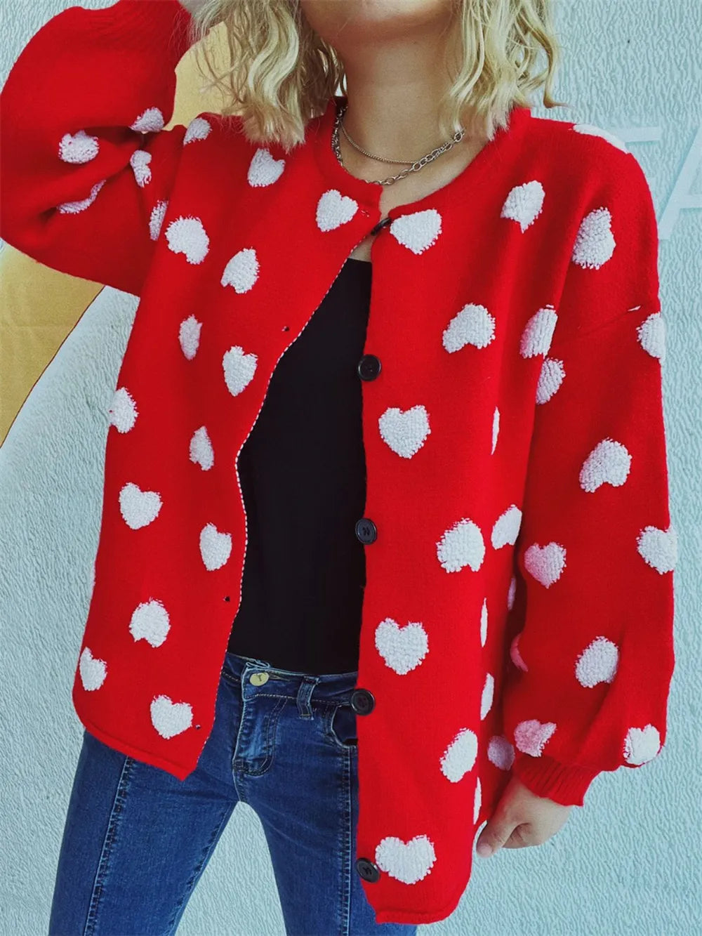 Cozy Heart Button Front Long Sleeve Knit Cardigan in red with white heart pattern, worn over black top