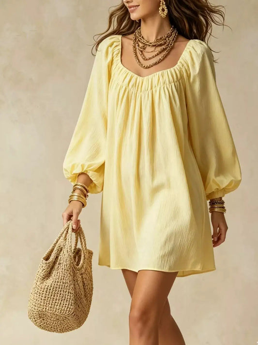 Flowy Balloon Sleeve Mini Dress in pale yellow with gathered neckline; woven straw bag