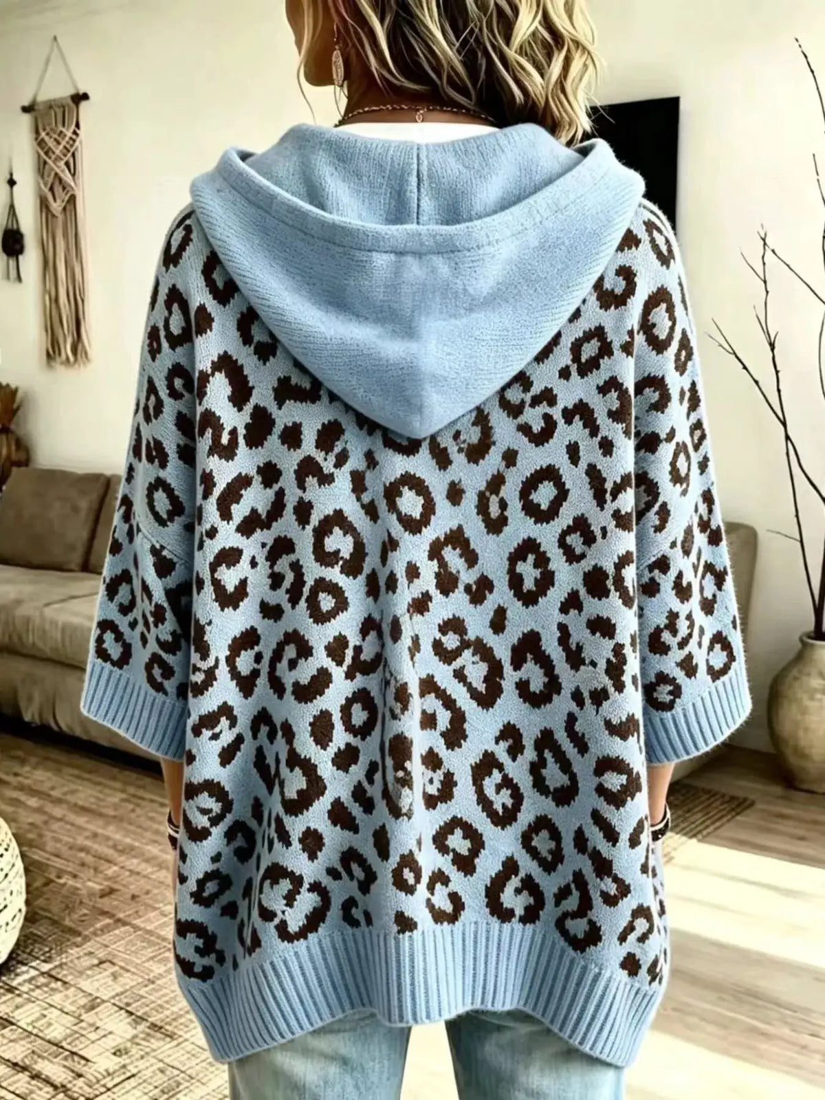 Drawstring leopard hooded sweater in light blue with brown leopard print; ribbed cuffs and hem, back view.