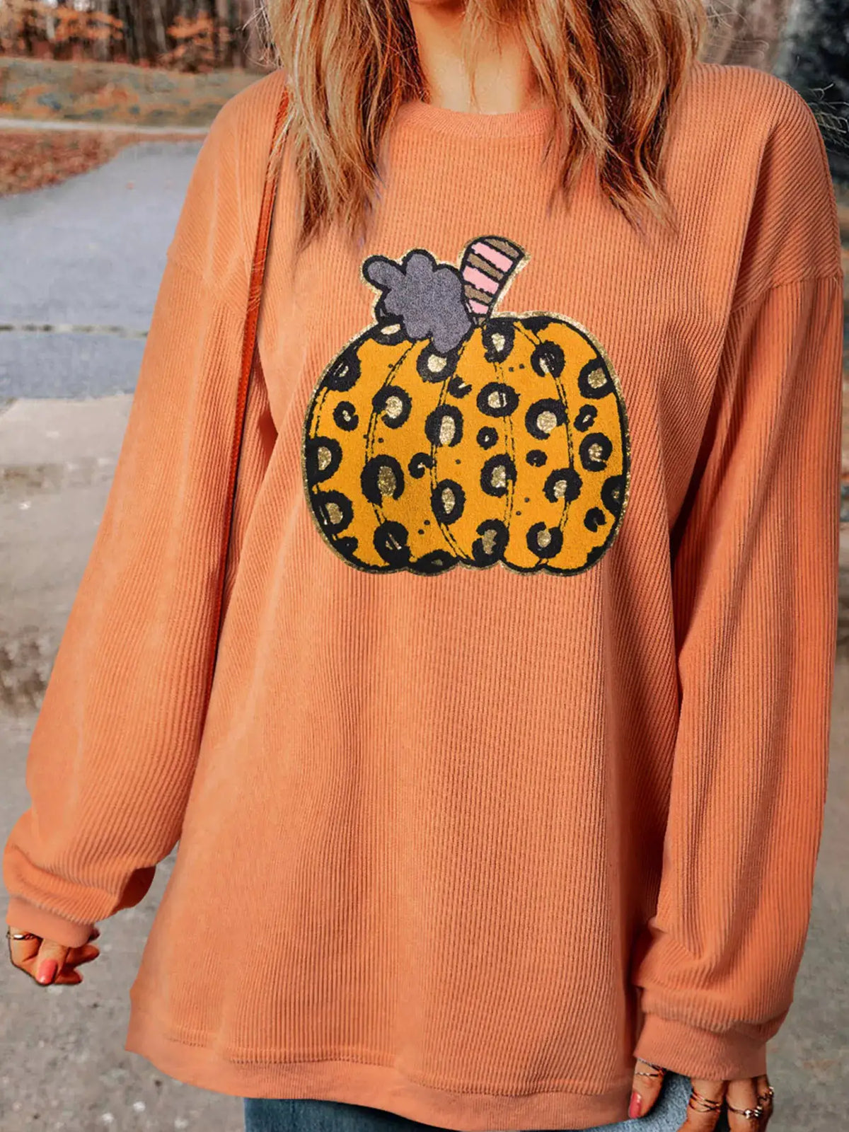 Halloween Leopard Pumpkin Patchwork Ribbed Sweatshirt in orange with leopard-print pumpkin graphic.
