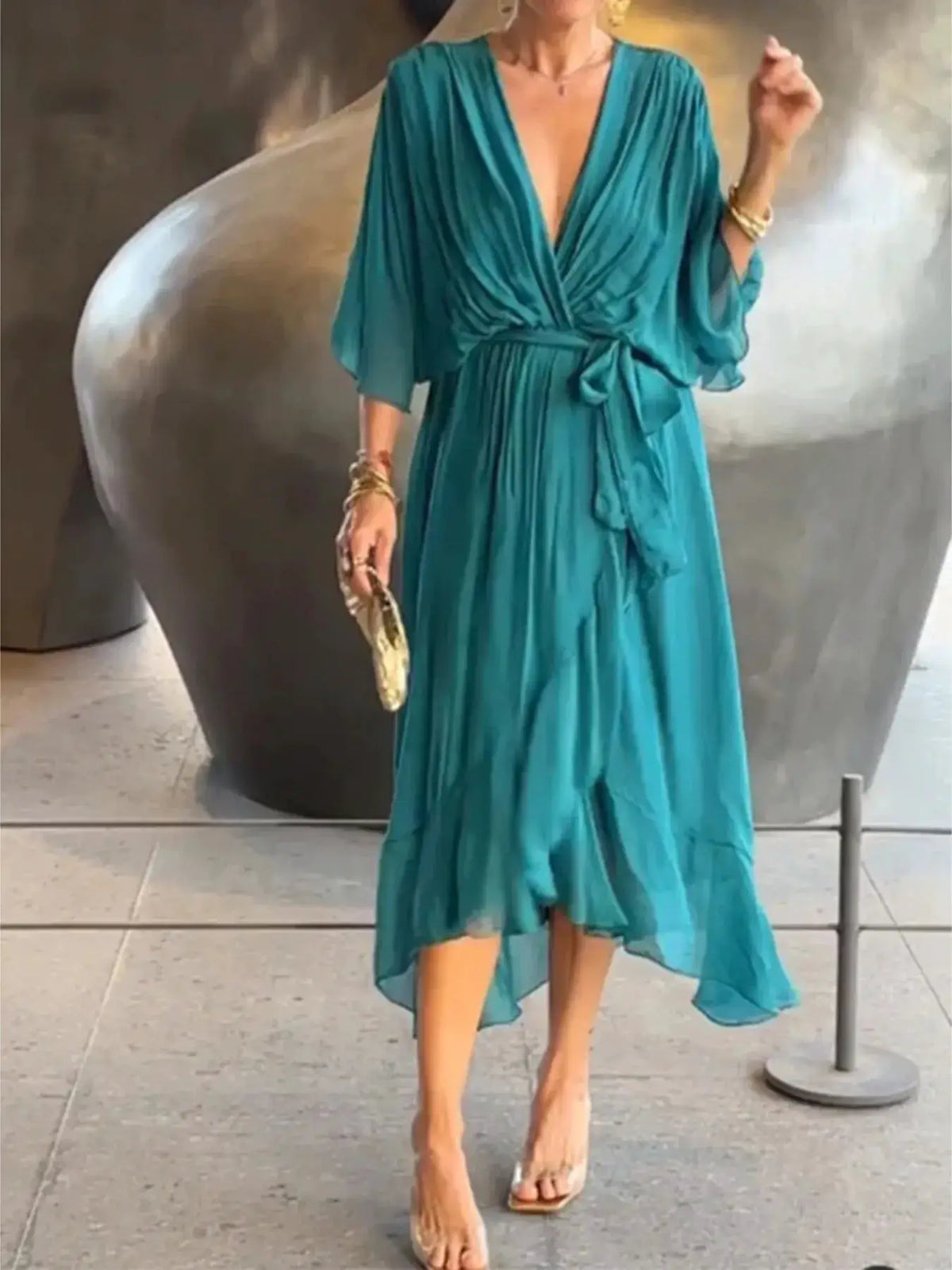 Teal plus-size flowy midi dress with flutter sleeves and front waist tie.