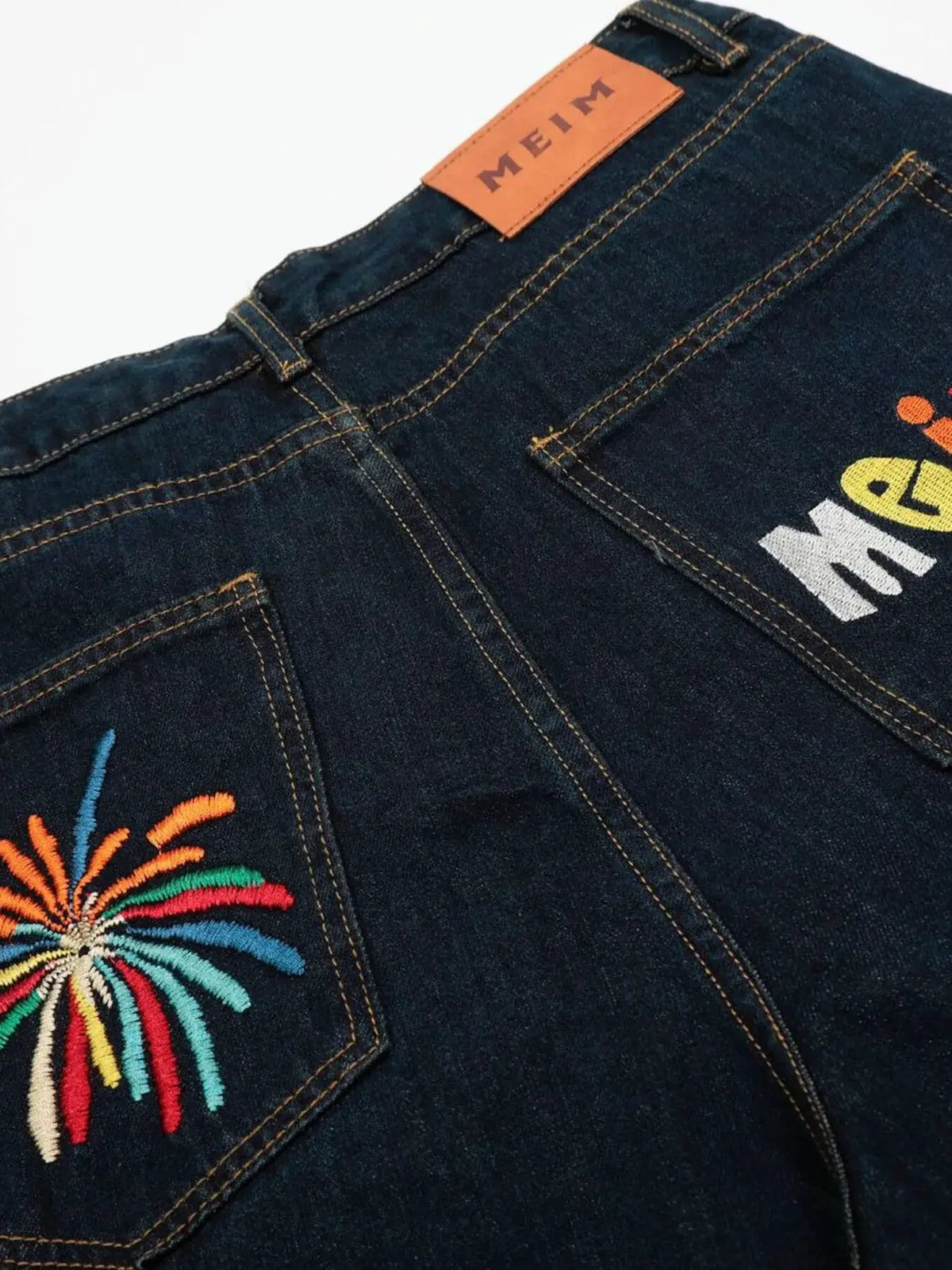 Oversized men's wide-leg denim shorts, 100% cotton, dark indigo with colorful pocket embroidery