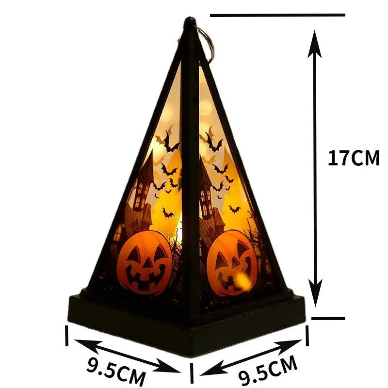Halloween pumpkin lantern with jack-o'-lantern faces, bats and haunted house silhouettes glowing on desktop decoration