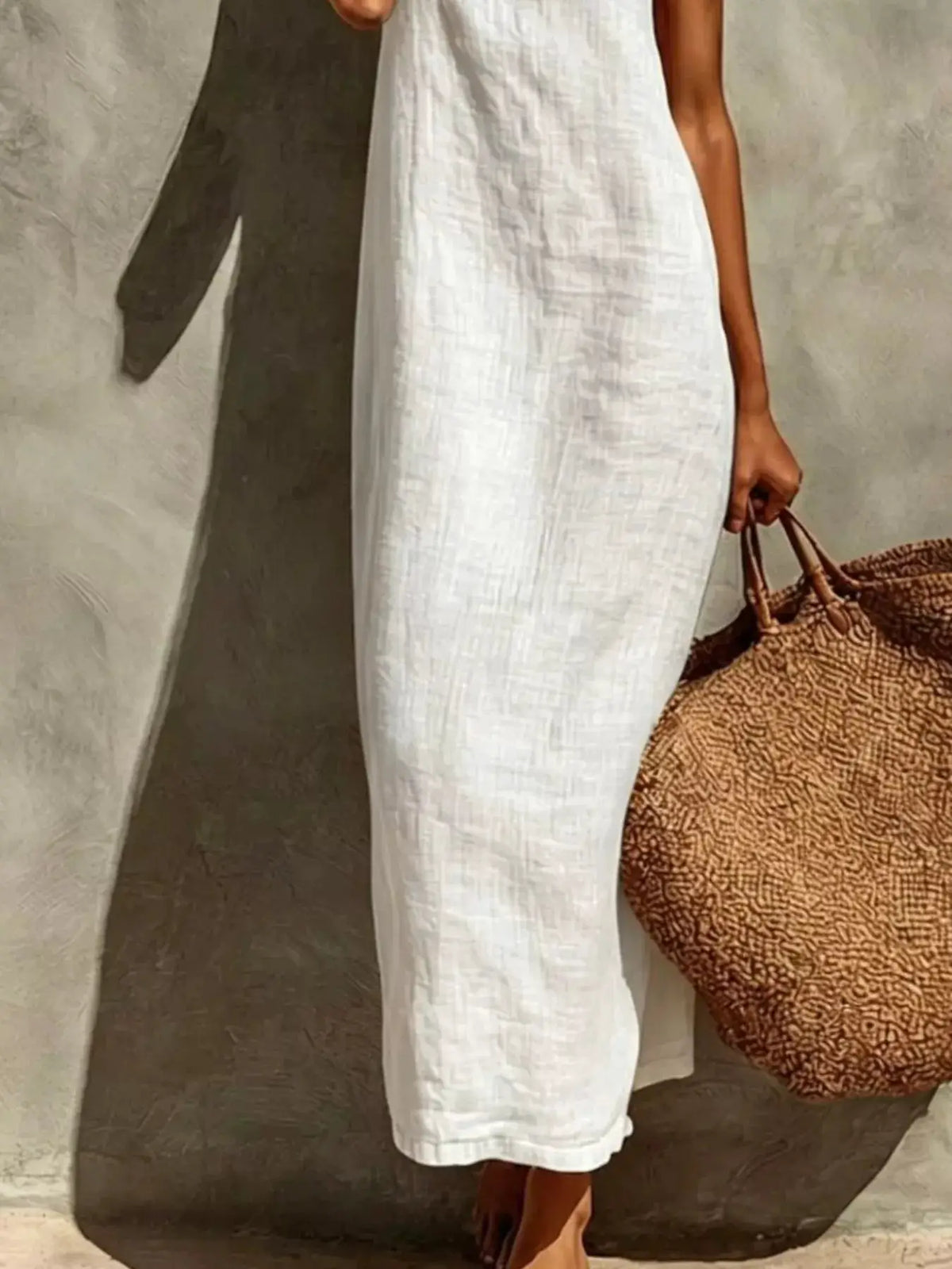 Sleeveless linen casual maxi dress in white with textured fabric; brown woven tote bag beside