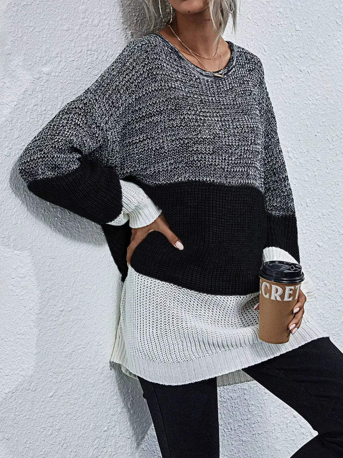 Color block oversized knit sweater with round neck in gray, white and black; relaxed fit.