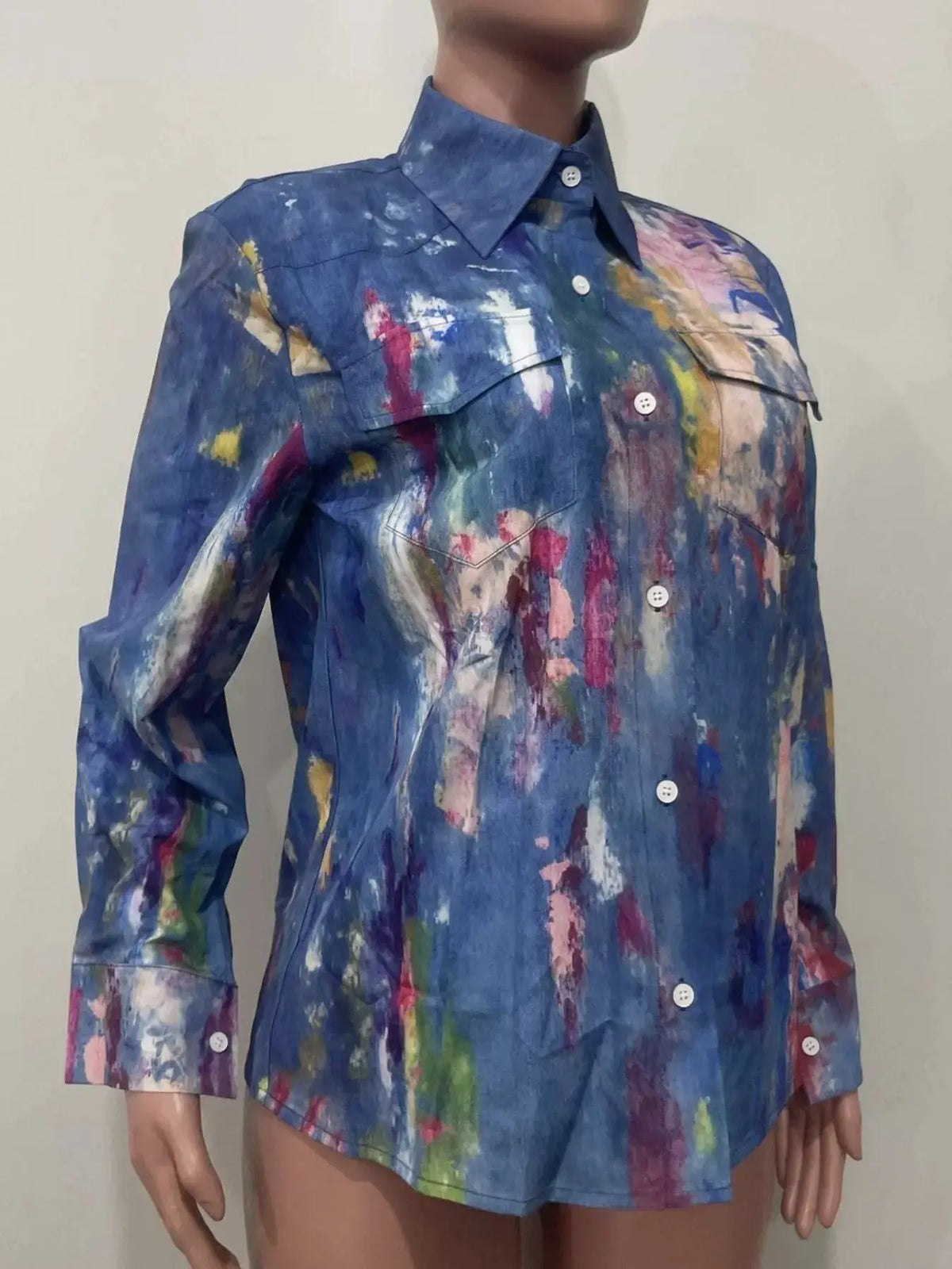 Women's hand-painted denim shirt with long sleeves, button-down front, blue base and colorful brushstroke patterns.