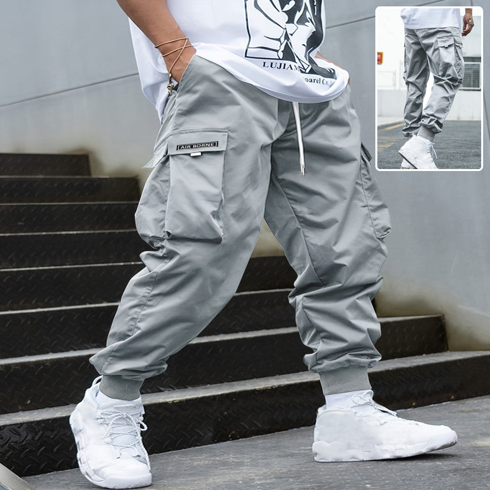 Multi-pocket cargo pants for men, grey drawstring trousers by AdTec.