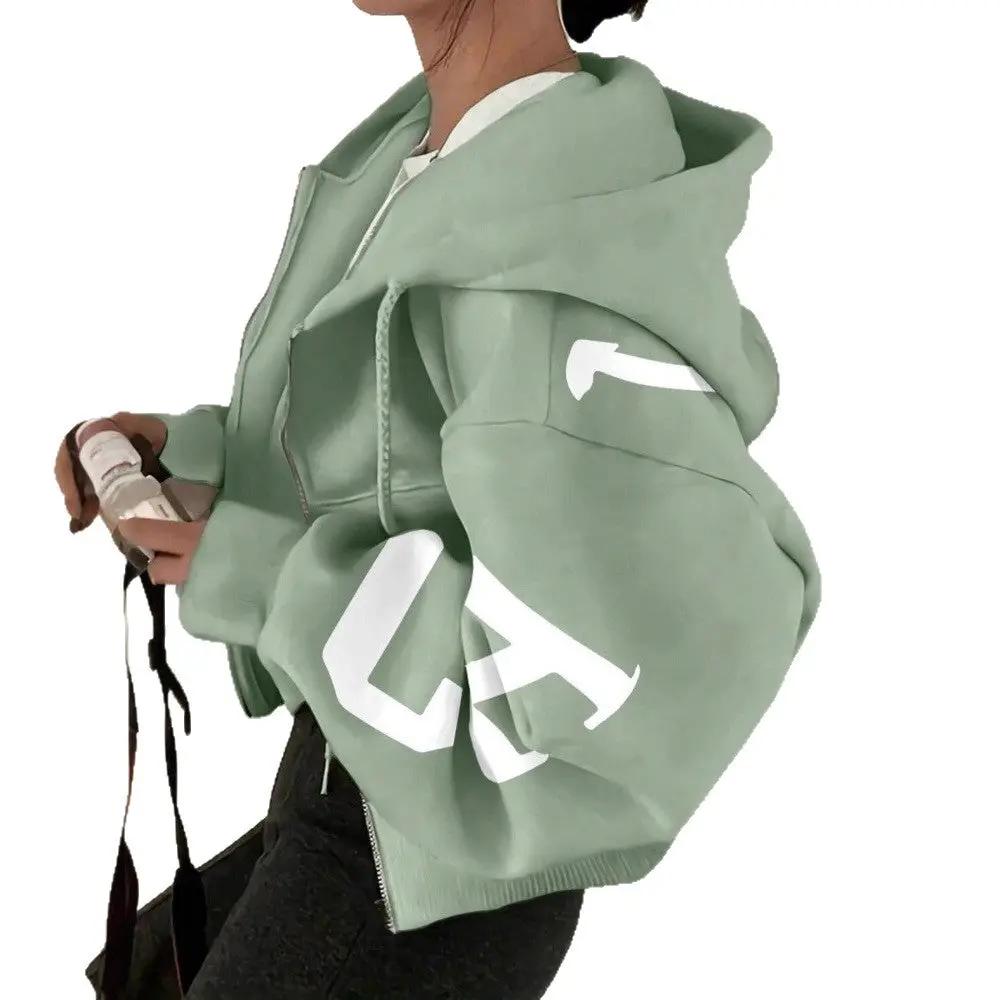 Soft full-zip long sleeve sweatshirt in sage green with oversized fit and white graphic on the sleeve; AdTec.