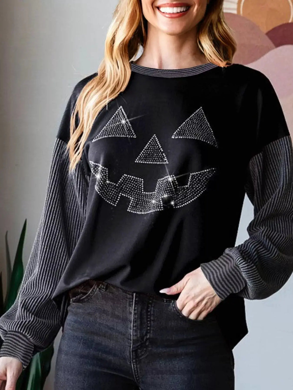 Halloween Rhinestone Pumpkin Face Top black with dotted jack-o'-lantern design and ribbed striped long sleeves