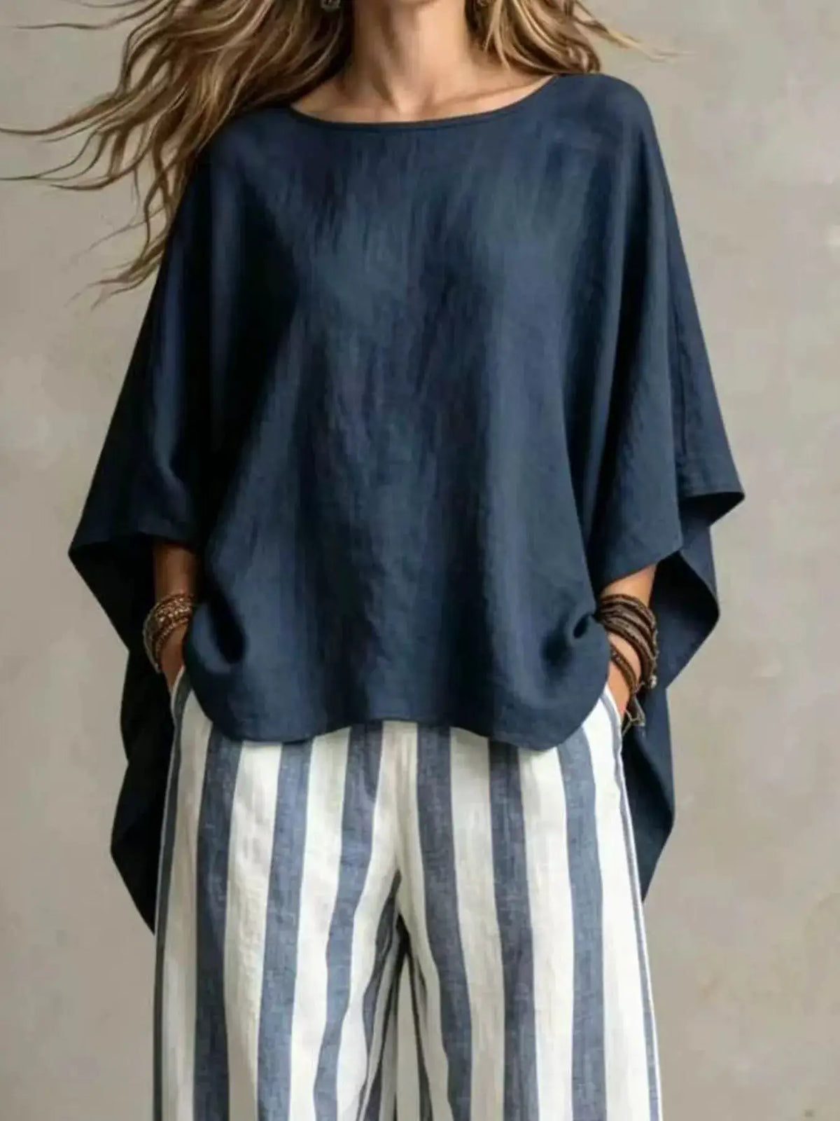 Plus-size navy solid top with batwing sleeves paired with blue-and-white vertical striped pants