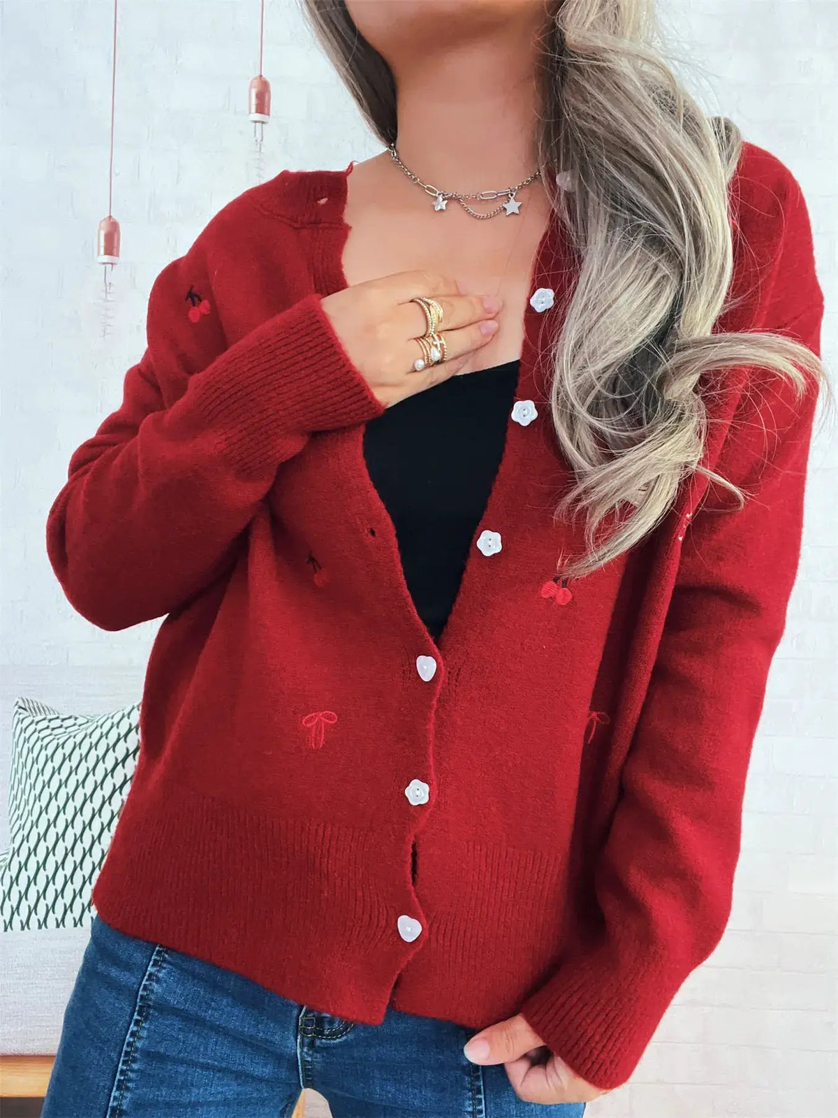 Trendsi red ribbed knit cardigan with white heart buttons, button-front over a black top.