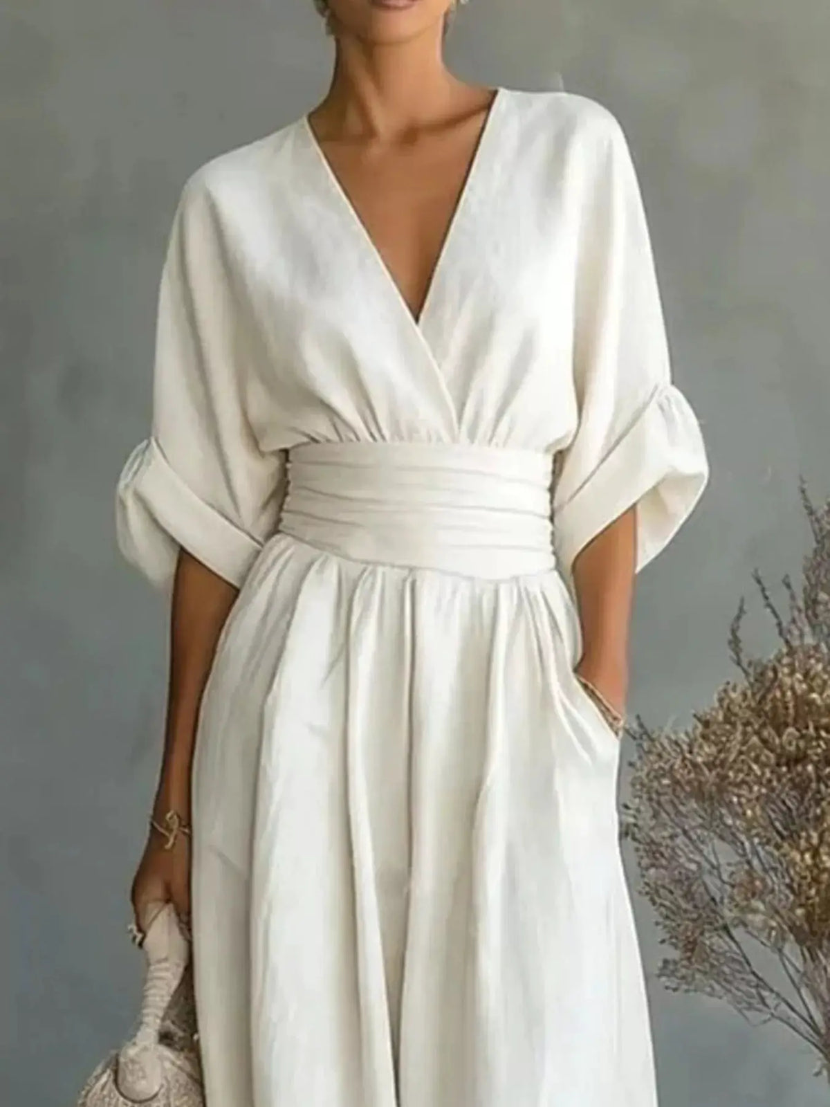Jumpsuit by Trendsi in cream with wrap V-neck, ruched waist, and wide-leg pants.