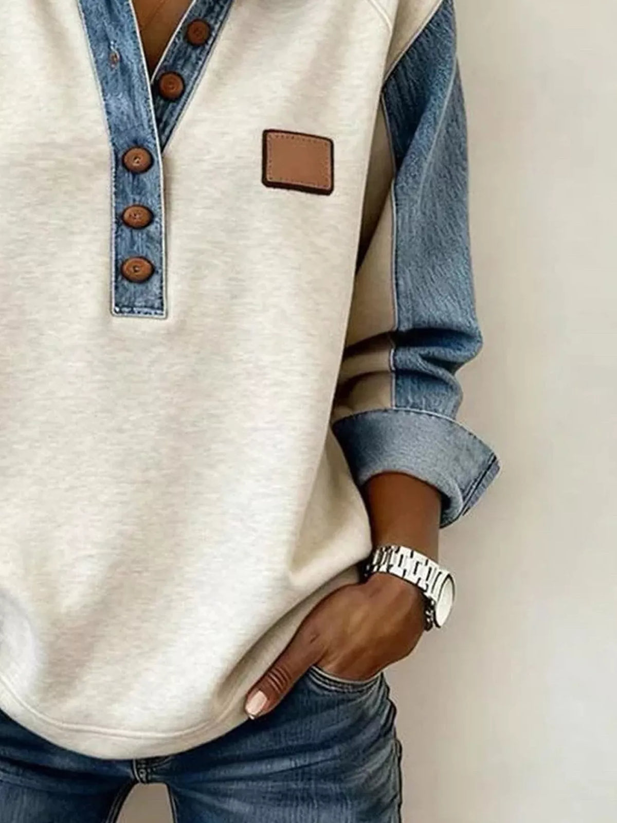 Denim Trim Button Detail Sweatshirt with beige body and blue denim sleeves, brown buttons