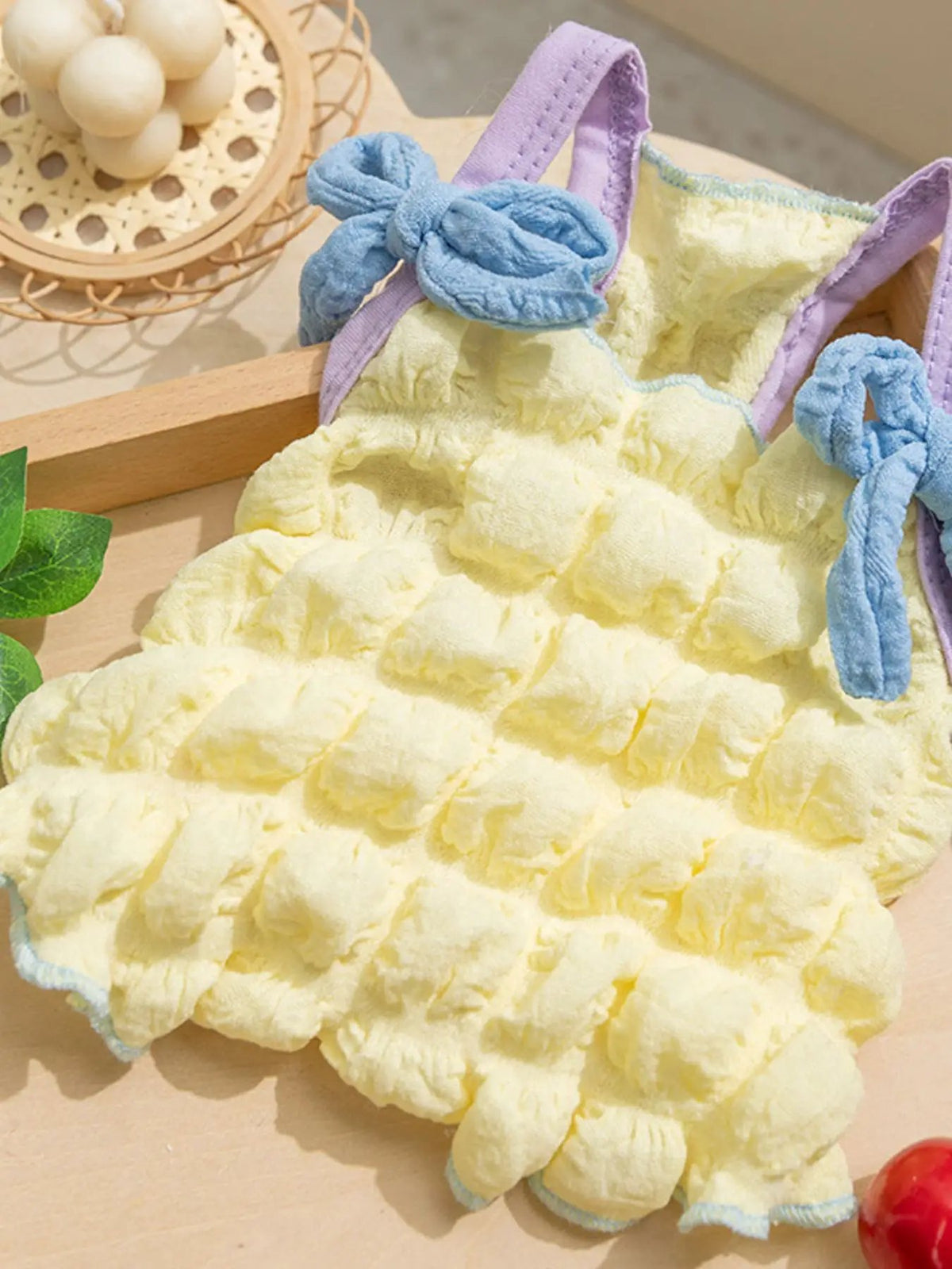 Bubble-textured tie-shoulder pet top by Trendsi; yellow fluffy fabric with lavender straps and blue bows