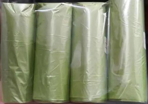 Five green cylindrical plastic rolls in clear wrap, neatly aligned in a row for product display purposes