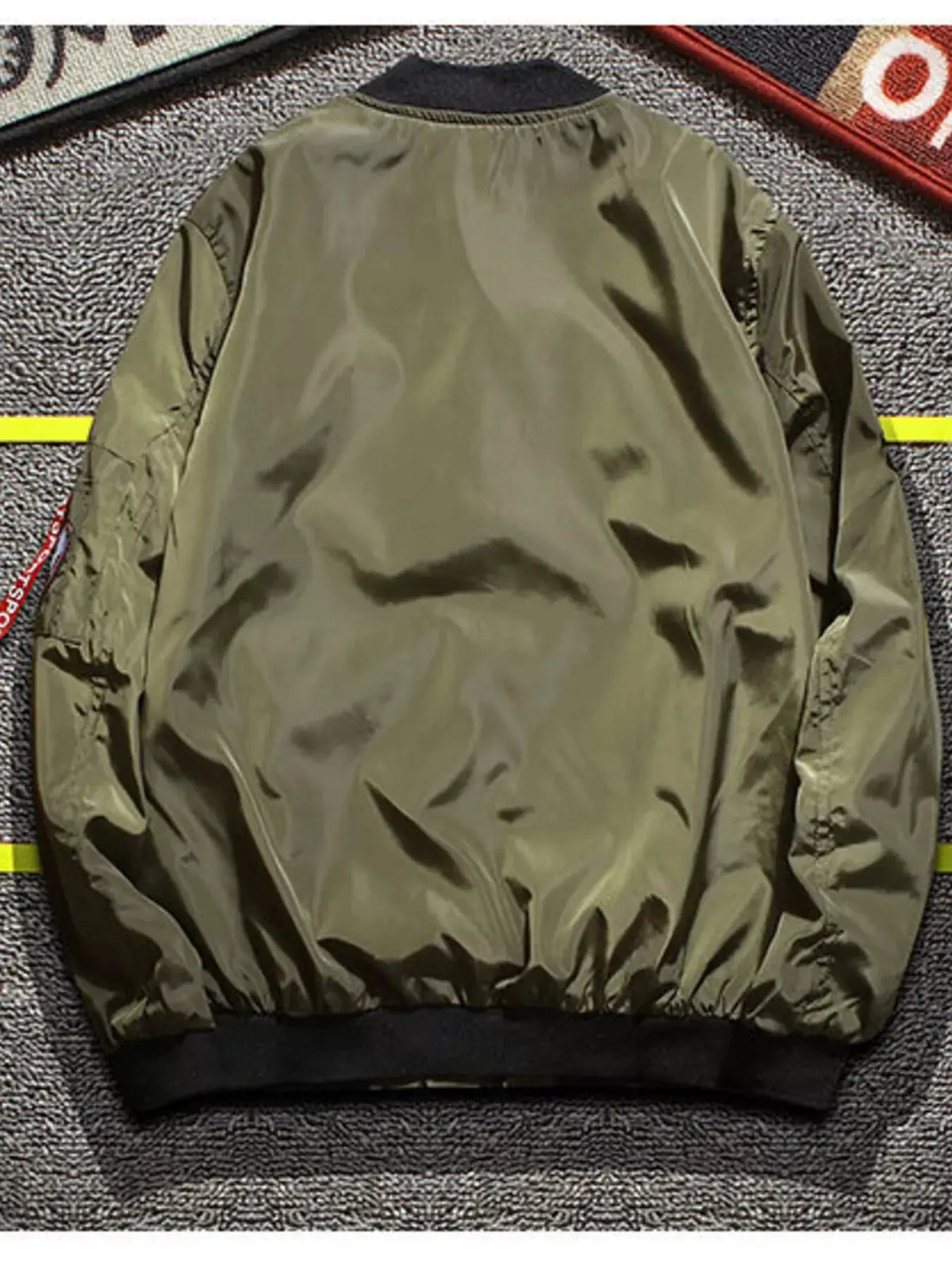 Men's plus-size olive green nylon bomber jacket with military patches on sleeves