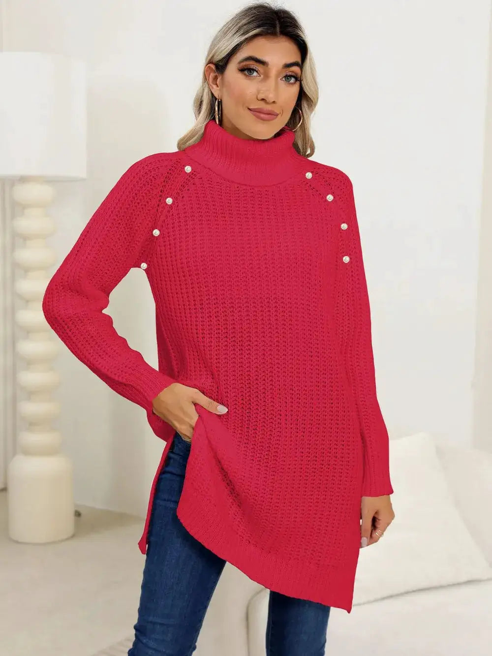 Women's slit turtleneck long sleeve stretchy knit pullover sweater in bright red with pearl-embellished shoulders.