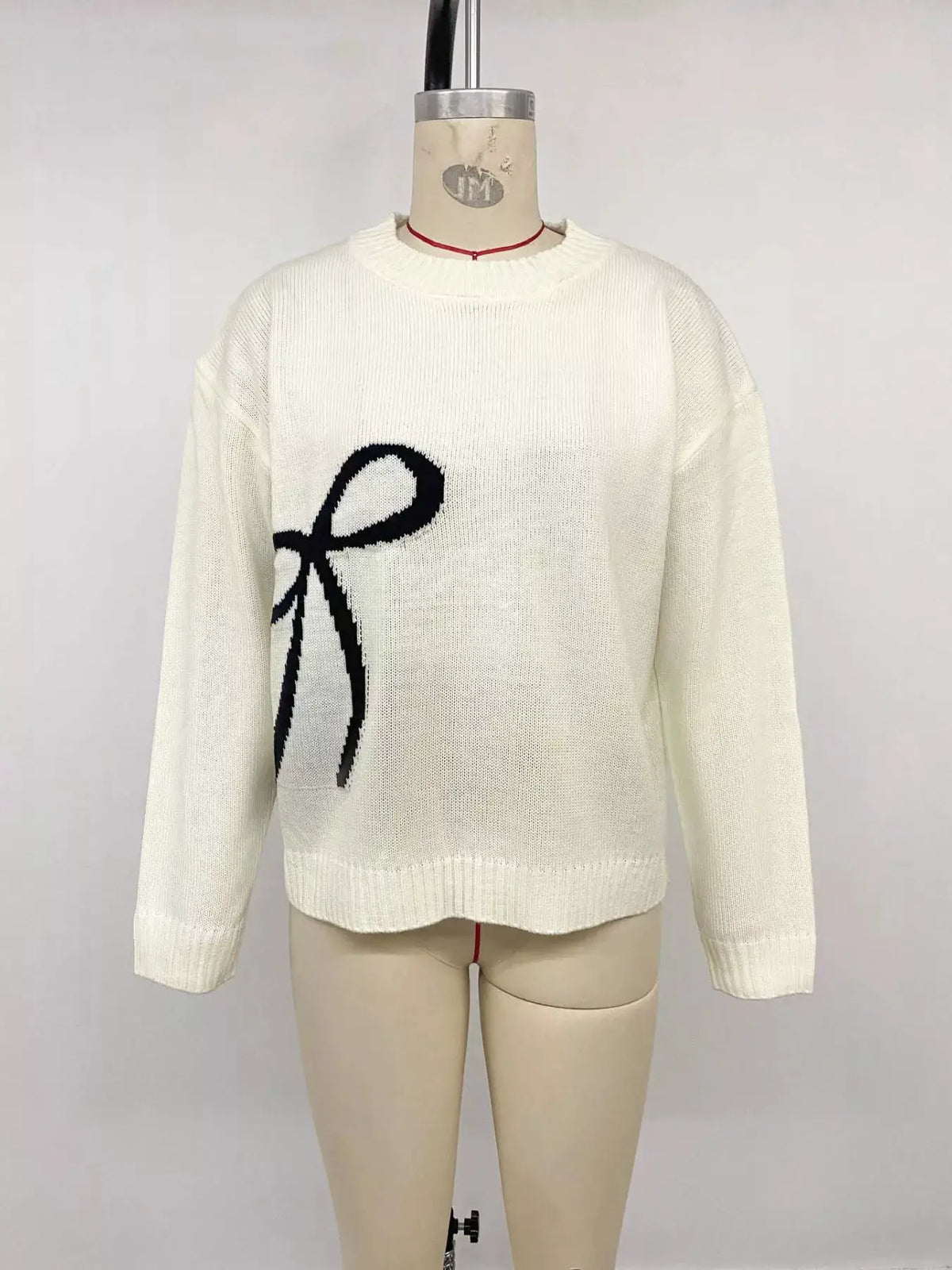 Bow Graphic Round Neck Acrylic Sweater in white with a large black bow and soft stretch fit.