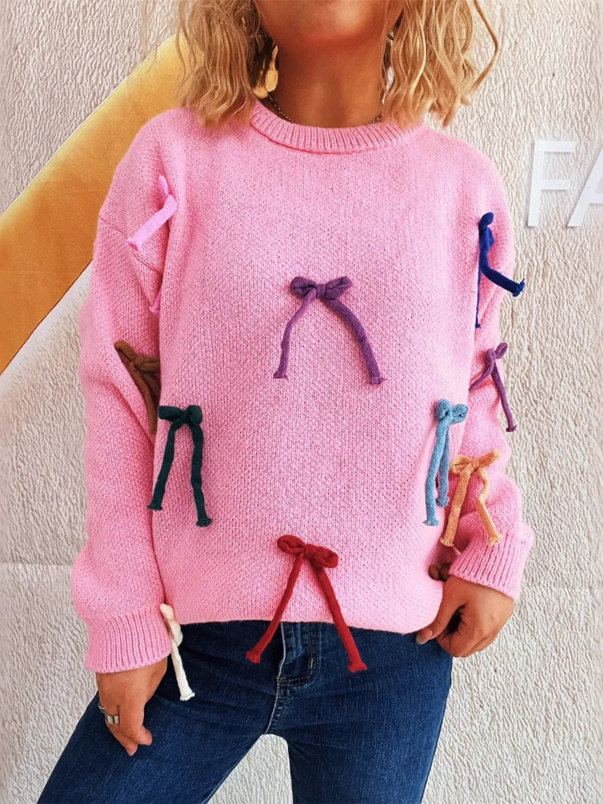 Trendsi pink bow-accent round-neck sweater for women with multicolor bows on sleeves and front