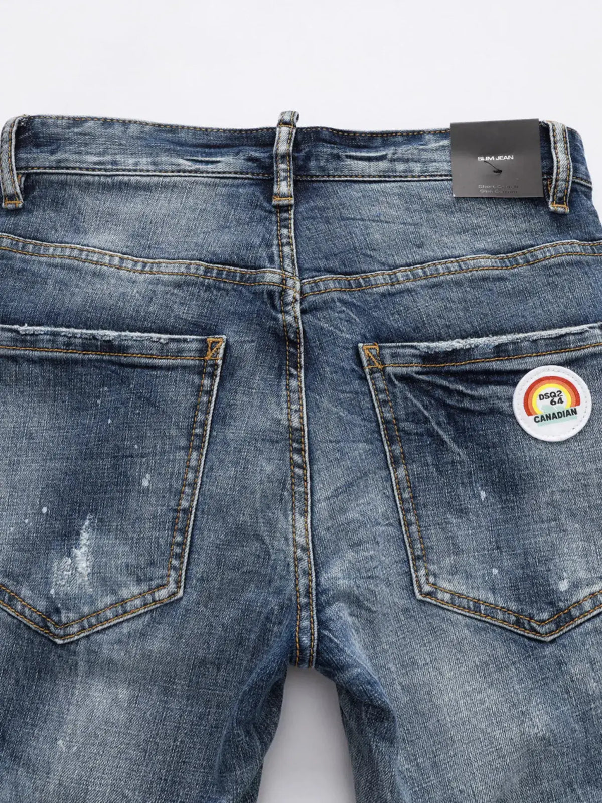 Men's Distressed Slim-Fit Jeans in blue denim with back pockets and Canadian patch.