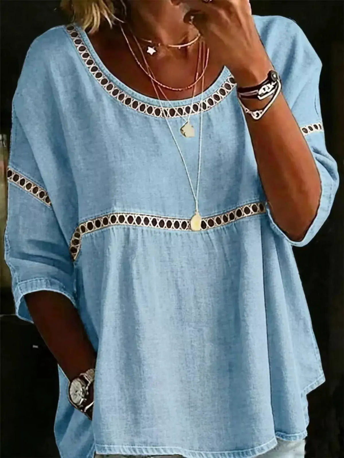 Plus-size hollow-out round-neck top in light blue chambray with openwork trim along neckline and across sleeves
