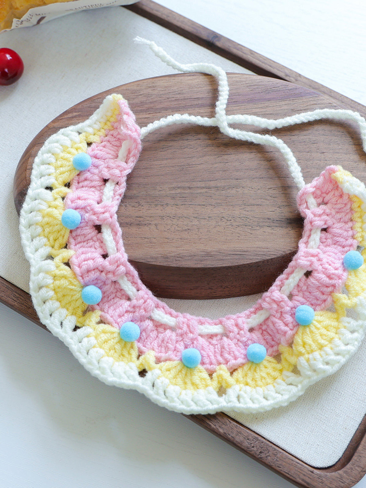Contrast Pet Scarf, pastel pink and yellow crochet with white trim and blue beads.