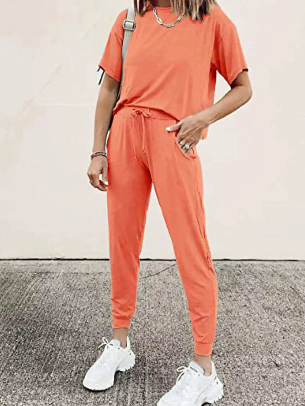 Full-Size coral round-neck top and drawstring pants set for plus size by Trendsi