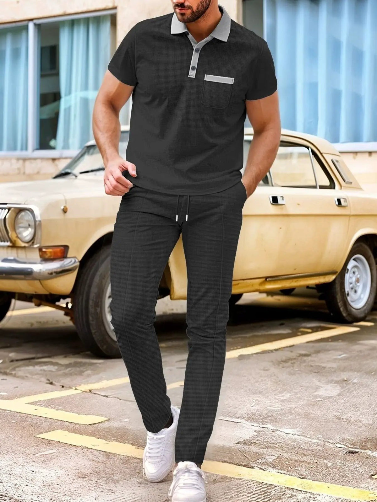 Men's matching short-sleeve polo and pants set in dark charcoal with gray collar and pocket trim, plus-size.