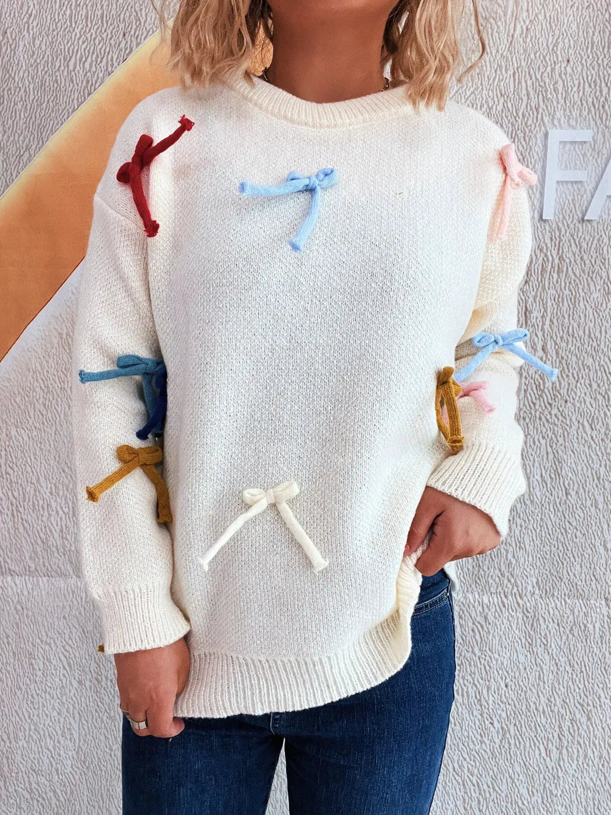 Vibrant bow-accent round-neck sweater for women, white knit with multicolor bow details on sleeves and chest