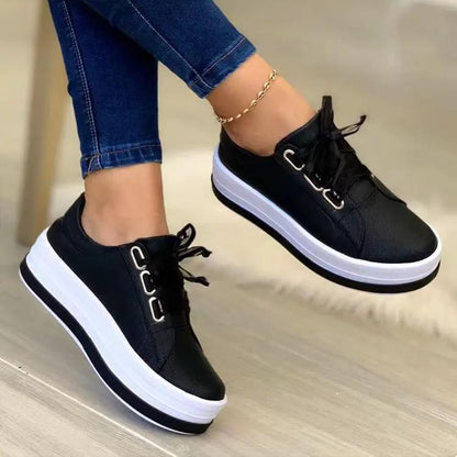 AdTec women's black lace-up platform sneakers with a white chunky sole and round toe.