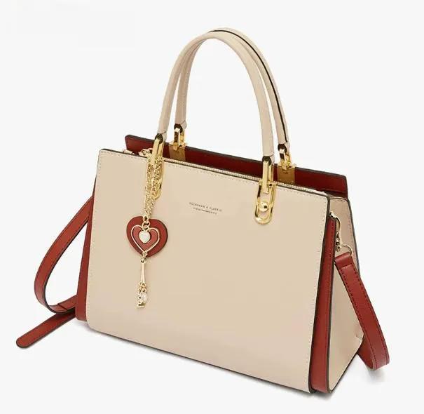 AdTec handbag beige with red trim and gold hardware; top handles and removable shoulder strap.