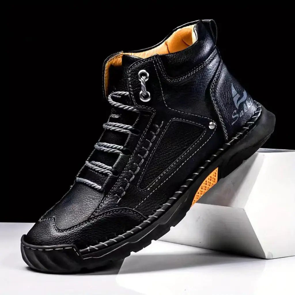 Aveline Handcrafted Ankle Boot by AdTec, black leather with orange lining and rugged flat-heel sole.