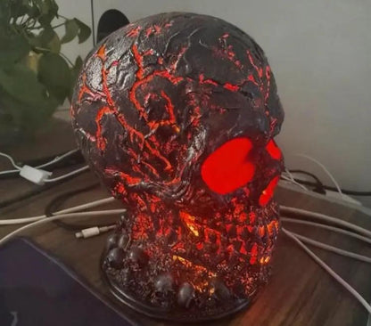 Halloween lava-stone skull lamp with red LED eyes and crackled glow for spooky desk or mantel decor