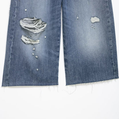 Denim shorts with navy blue color and distressed holes, mid-waist, frayed hems