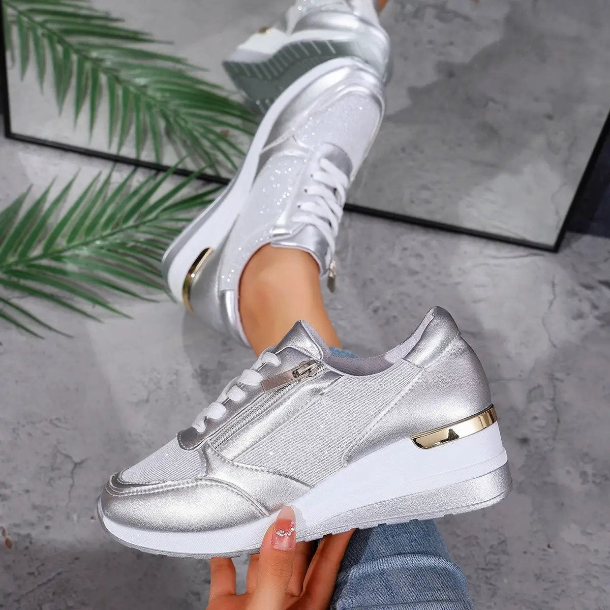 Women's lace-up sneakers in silver metallic with side zipper.