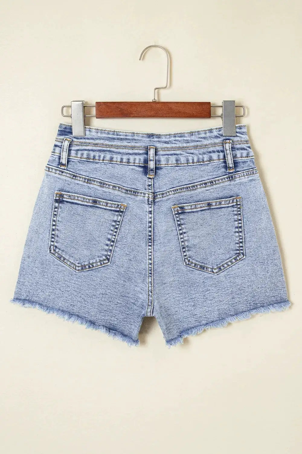 Women's high-waist light-wash denim shorts with raw hem and back pockets