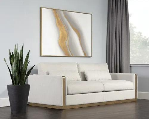 Lean Sofa Belfast Oatmeal, cream upholstery with gold-tone trim and wooden base