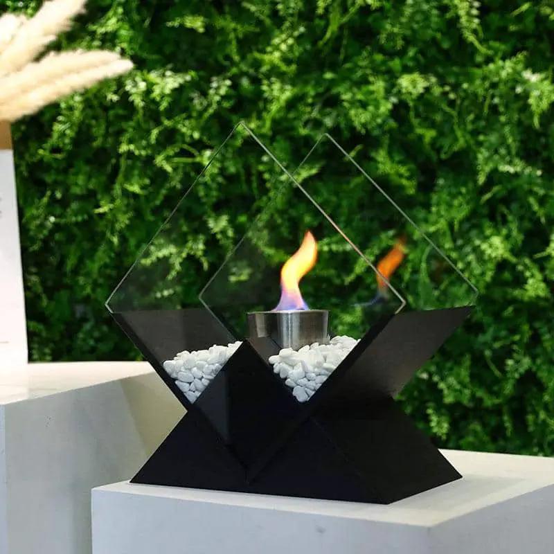 JHY DESIGN tabletop fireplace; black geometric metal base, glass panels, white pebbles, ventless bio-ethanol flame.