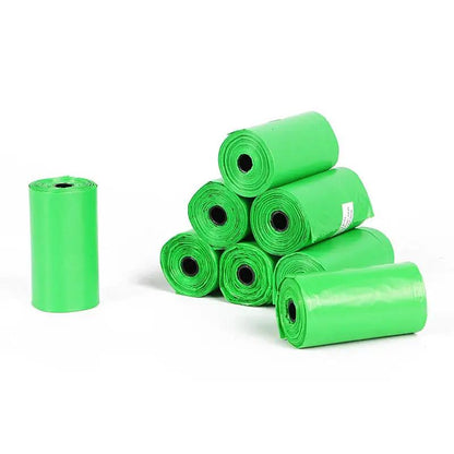 Degradable dog poop bags in bright green rolls, seven-pack for easy pickup.